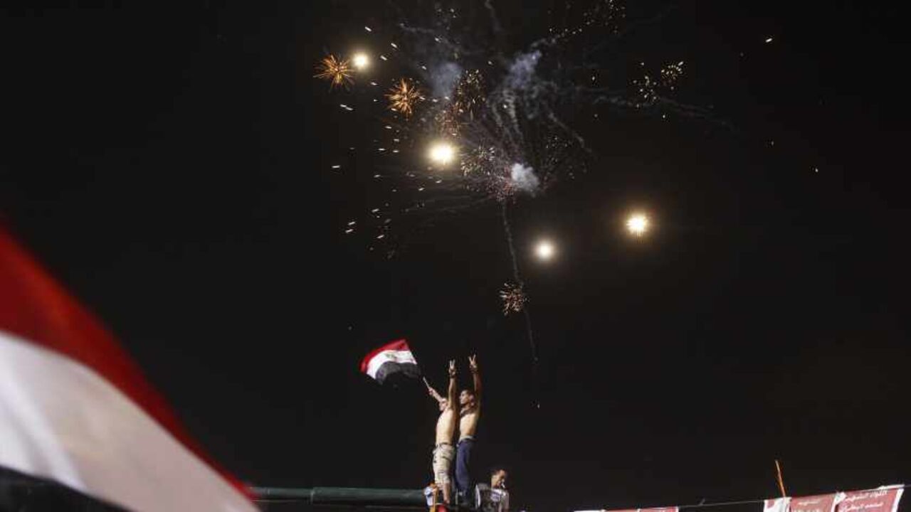 Anti-Mursi protesters celebrate in Tahrir square after the announcement of the removal from office of Egypt's deposed President Mohamed Mursi in Cairo Anti-Mursi protesters celebrate in Tahrir square after the announcement of the removal from office of Egypt's deposed President Mohamed Mursi in Cairo, July 3, 2013. Mursi, toppled by the military on Wednesday, is being held by the authorities, a Muslim Brotherhood spokesman and a security official said on Thursday. REUTERS/Asmaa Waguih (EGYPT - Tags: POLITICS CIVIL UNREST TPX IMAGES OF THE DAY) - RTX11BTC
