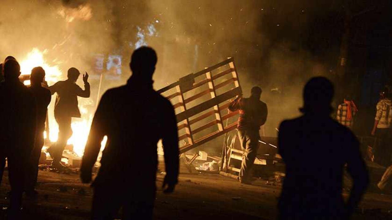 TURKEY-PROTESTS/ALEVIS Demonstrators set barricades on fire as they clash with riot police during a protest in the Tuzlucayir neighbourhood of Ankara September 9, 2013. Billed as a symbol of peace between two faiths, a new place of worship has turned Tuzlucayir, a poor suburb of Ankara, into a battleground and exposed wider sectarian tensions within Turkey. The project's blueprint envisages a Sunni mosque rising side by side with a new cemevi, or assembly house, to be used by Alevis, Turkey's biggest religious minority. But with