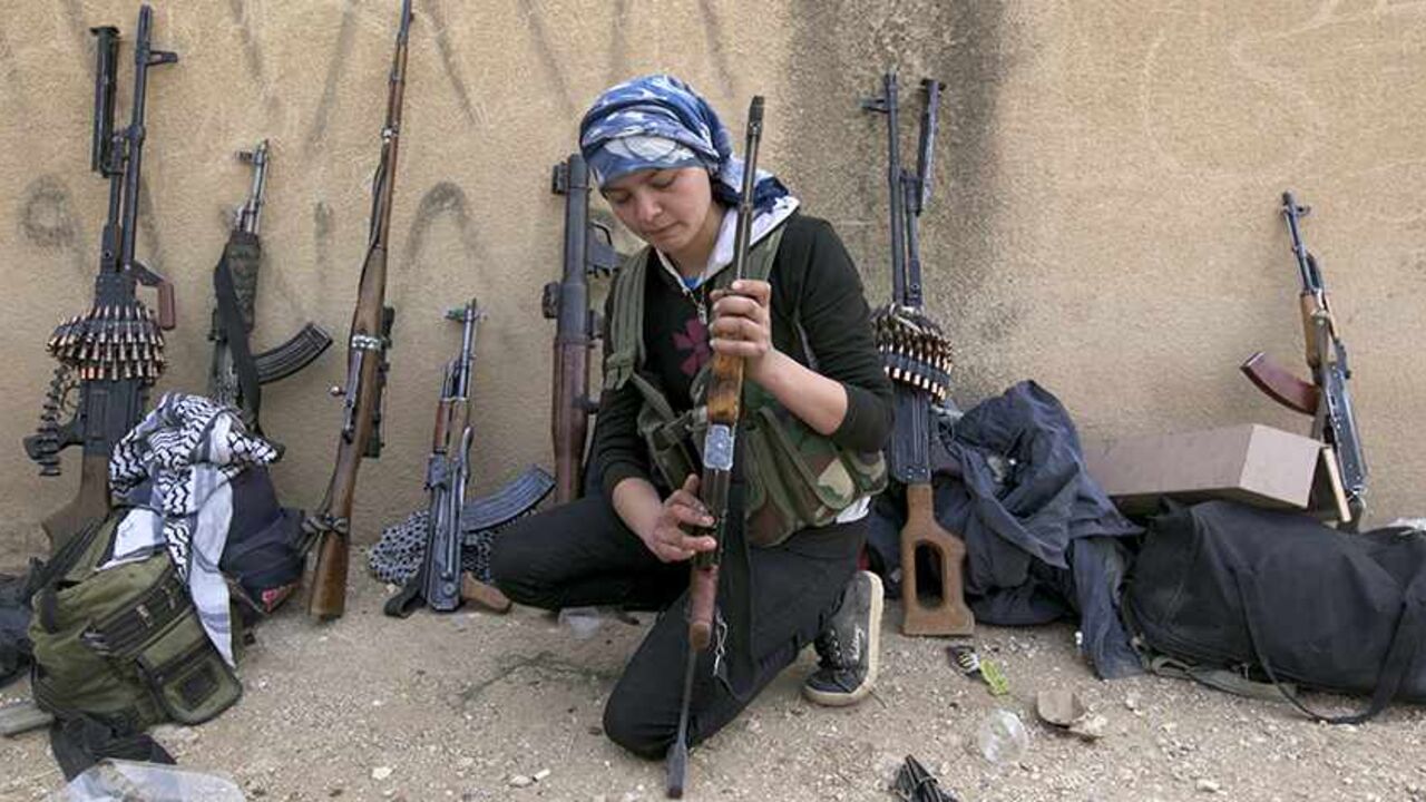 SYRIA-CRISIS/KURDS A Kurdish female fighter from Kurdish People's Protection Units (YPG) checks her weapon near Ras al-Ain, in the province of Hasakah, after capturing it from Islamist rebels November 6, 2013. Redur Xelil, spokesman for the armed wing of the Syrian Kurdish Democratic Union Party (PYD), said Kurdish militias had seized the city of Ras al-Ain and all its surrounding villages. Syrian Kurdish fighters have captured more territory from Islamist rebels in northeastern Syria, a Kurdish militant group said on Monday,