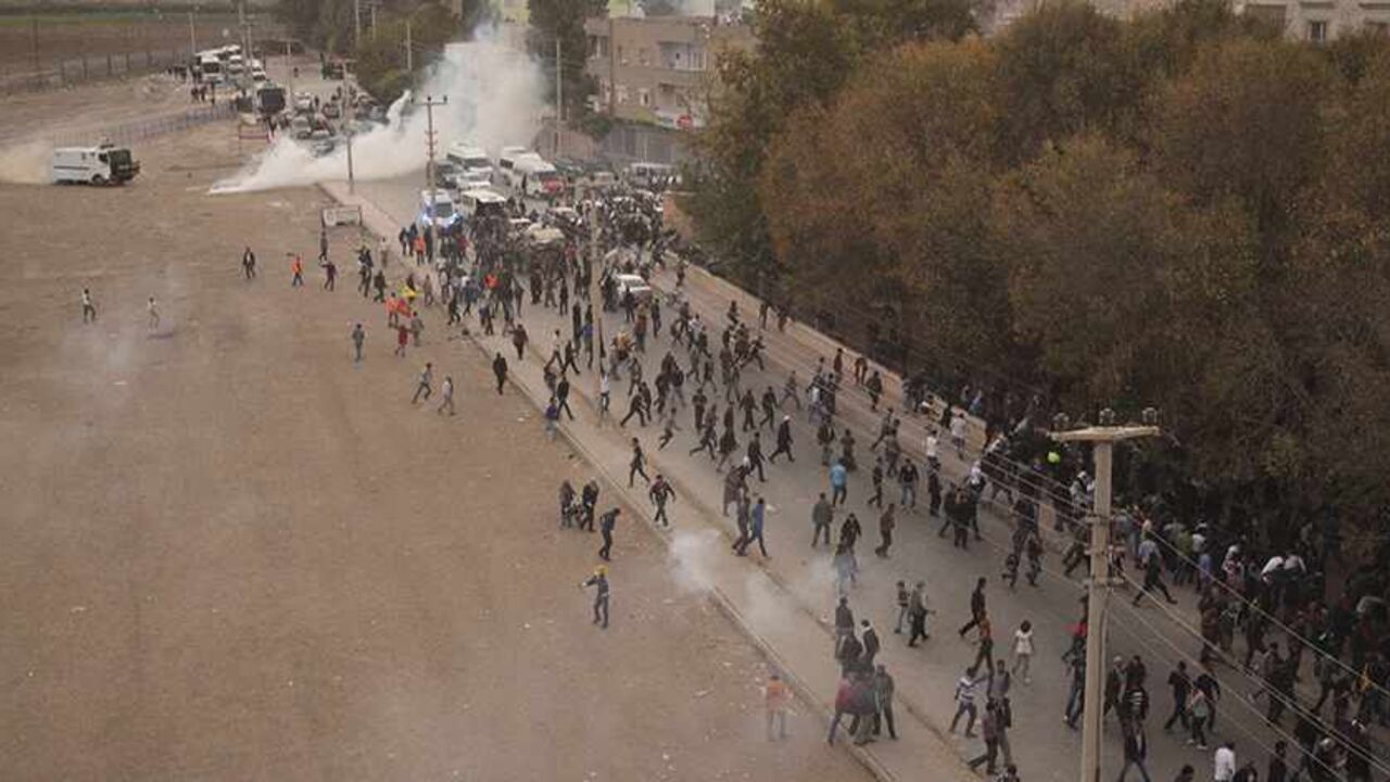 SYRIA-CRISIS/TURKEY-KURDS Riot police use tear gas to disperse pro-Kurdish demonstrators during a protest in the southeastern Turkish town of Nusaybin, on the Turkish-Syrian border, November 7, 2013. Thousands of Kurds protested on Thursday against Turkish plans to build a wall along the Syrian border, calling it a move to stop Kurdish communities strengthening cross-frontier ties as Syria splinters from civil war. Nusaybin is separated from the Syrian town of Qamishli by a strip of no-man's land and barbed wire fencing. REUTERS/Str