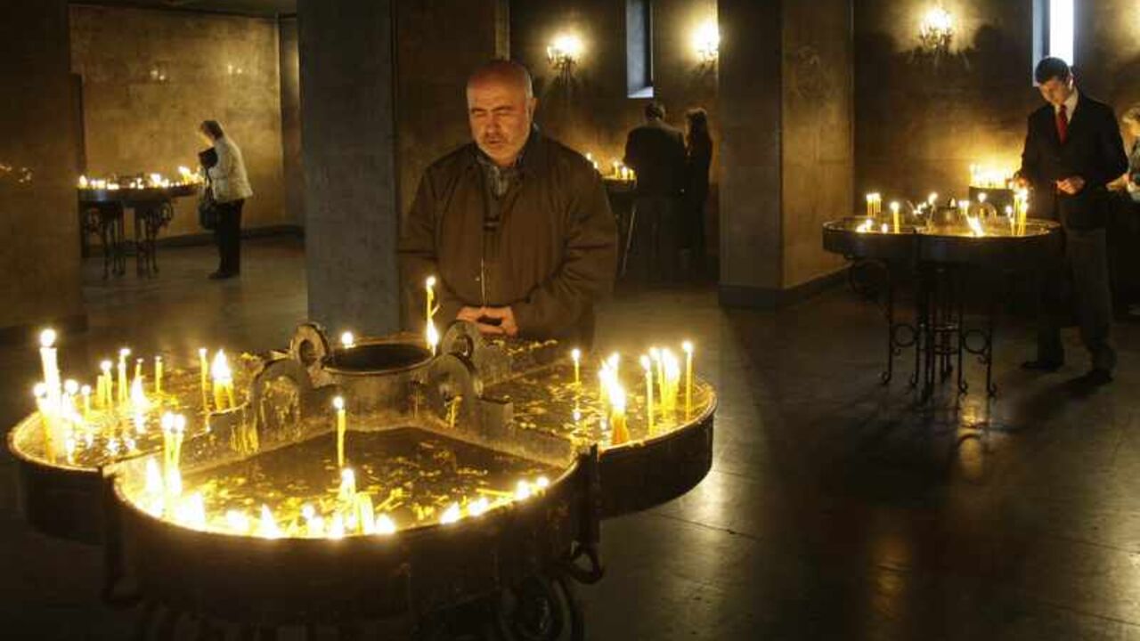 People light candles during a religious service to mark the anniversary of mass killings of Armenians in 1915, in Yerevan April 23, 2010. Steeped in history and surrounded by mountains, Armenia's capital Yerevan offers lively cafes, a bustling weekend market, stunning scenery and a rich religious heritage as one of the world's oldest continuously inhabited cities. Picture taken April 23, 2010.   REUTERS/David Mdzinarishvili (ARMENIA - Tags: RELIGION ANNIVERSARY TRAVEL SOCIETY) - RTX154W3