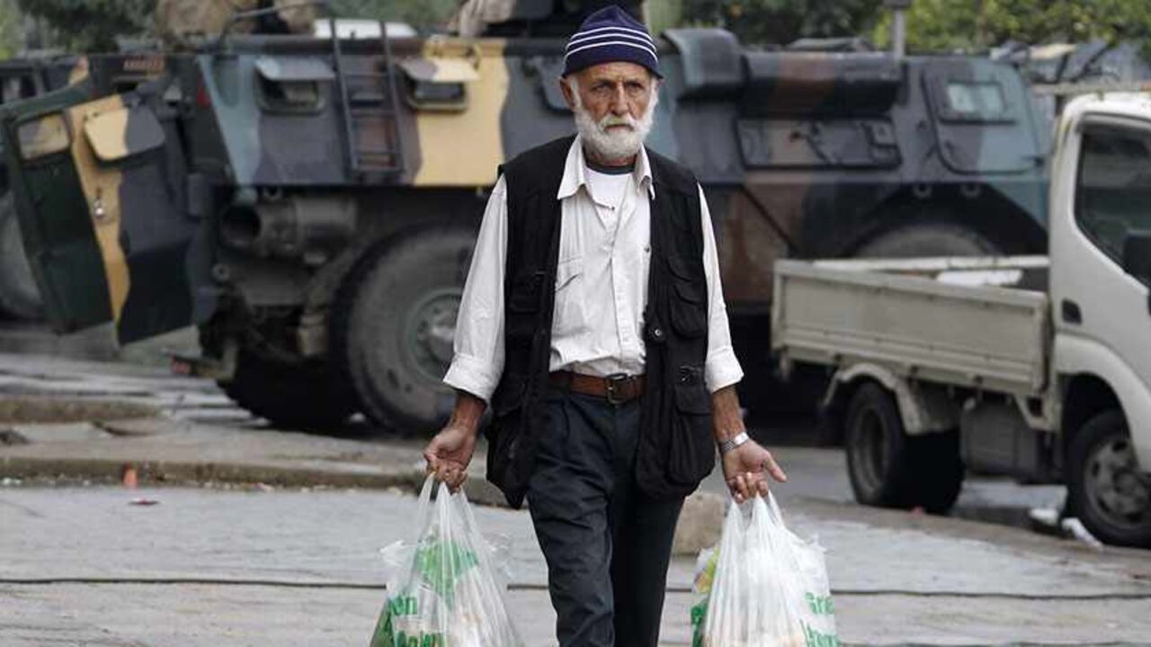 LEBANON-TRIPOLI/ARMY A man holding groceries walks in Tripoli, northern Lebanon, December 3, 2013. The Lebanese government has told the army to take over security in the restive coastal city of Tripoli for six months, caretaker Prime Minister Najib Mikati said on Monday.Ten people were killed in weekend clashes between Tripoli's Alawite minority, which supports Syria's Alawite President Bashar al-Assad, and majority Sunni Muslims who back his foes. REUTERS/Mohamed Azakir (LEBANON - Tags: CIVIL UNREST MILITARY POLITICS) - RTX162