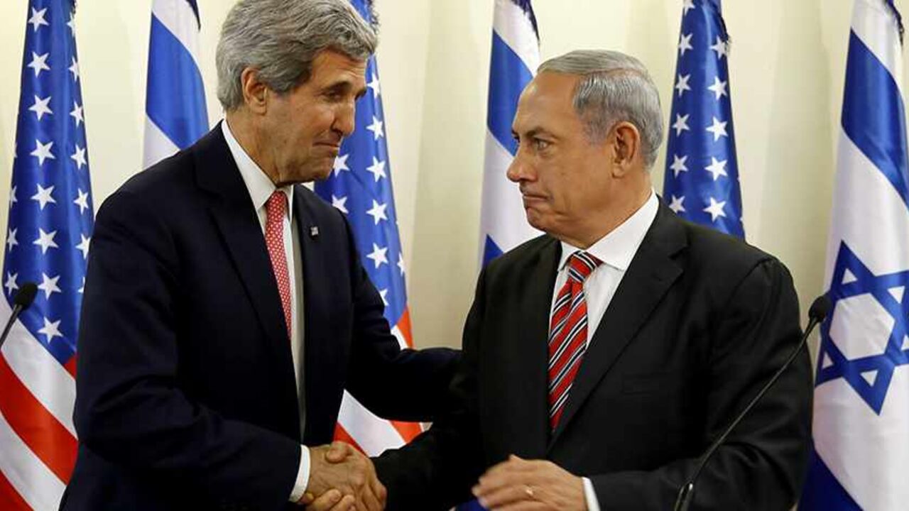 PALESTINIANS-ISRAEL/USA U.S. Secretary of State John Kerry shakes hands with Israeli Prime Minister Benjamin Netanyahu (R) during a news conference following a meeting at Netanyahu's office in Jerusalem December 5, 2013. Kerry said on Thursday that some progress had been made in Israeli-Palestinian peace talks and that he had presented Israel with ideas for improving its security under any future accord. REUTERS/Gali Tibbon/Pool (JERUSALEM - Tags: POLITICS) - RTX164NX