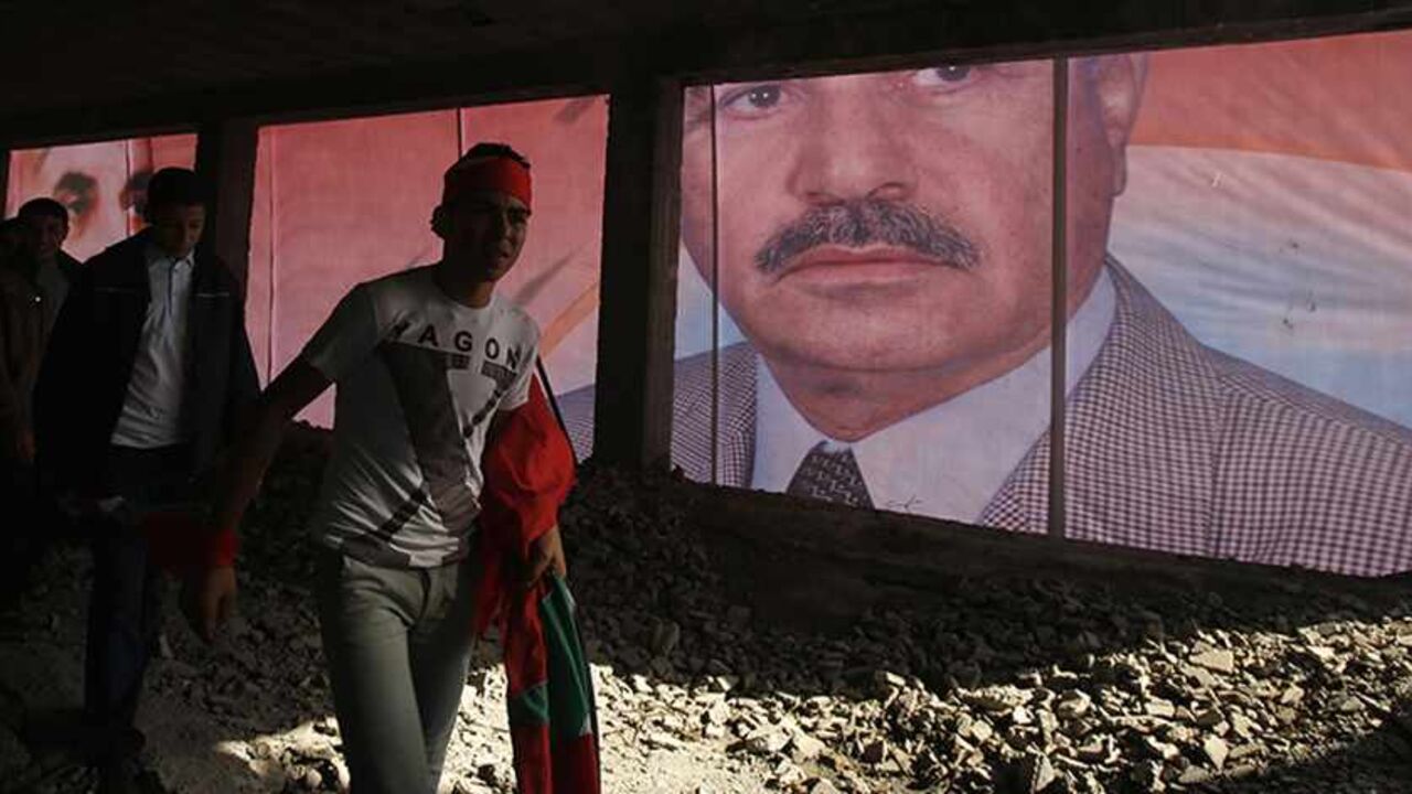 PALESTINIANS-ISRAEL/ A poster of late leader of the Popular Front for the Liberation of Palestine (PFLP) Abu Ali Mustafa is seen during a rally marking the 46th of the movement founding in Gaza City December 7, 2013. REUTERS/Suhaib Salem (GAZA - Tags: POLITICS CIVIL UNREST ANNIVERSARY) - RTX1682M