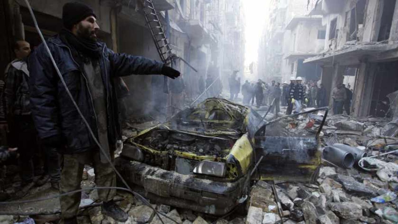 SYRIA-CRISIS Residents look for survivors at a damaged site after what activists said was an air strike from forces loyal to Syria's President Bashar al-Assad in Takeek Al-Bab area of Aleppo, December 15, 2013. REUTERS/Molhem Barakat (SYRIA - Tags: POLITICS CIVIL UNREST CONFLICT TPX IMAGES OF THE DAY) - RTX16JRO