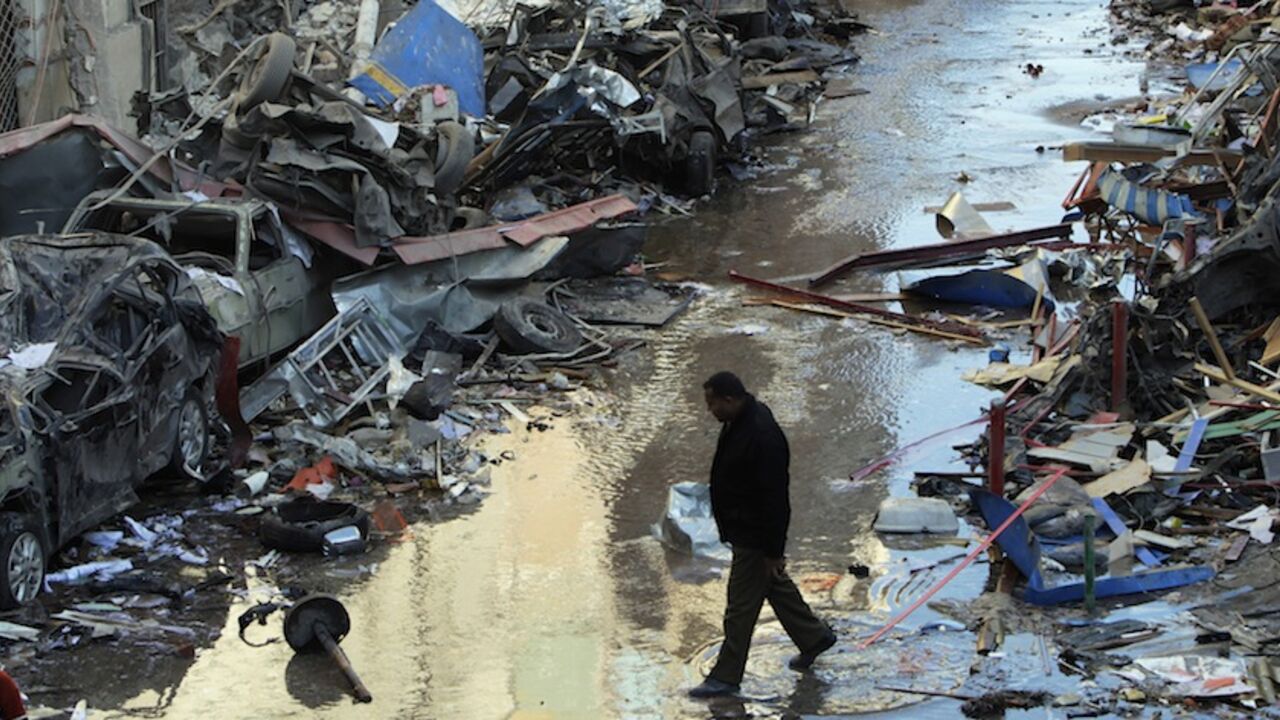 A man walks near debris after an explosion near a security building in Egypt's Nile Delta city of Mansoura in Dakahlyia A man walks near debris after an explosion near a security building in Egypt's Nile Delta city of Mansoura in Dakahlyia province, about 120 km (75 miles) northeast of Cairo December 24, 2013. Egypt's Muslim Brotherhood condemned the bomb attack on the security compound in the Dakahlyia which killed 12 people and wounded more than 100 early on Tuesday, a month before a vote on a new constitution key to transition from military-backed rule. REUTERS/Mohamed Abd El Ghany (EGYPT - Tags: POLITICS CIVIL UNREST DIS