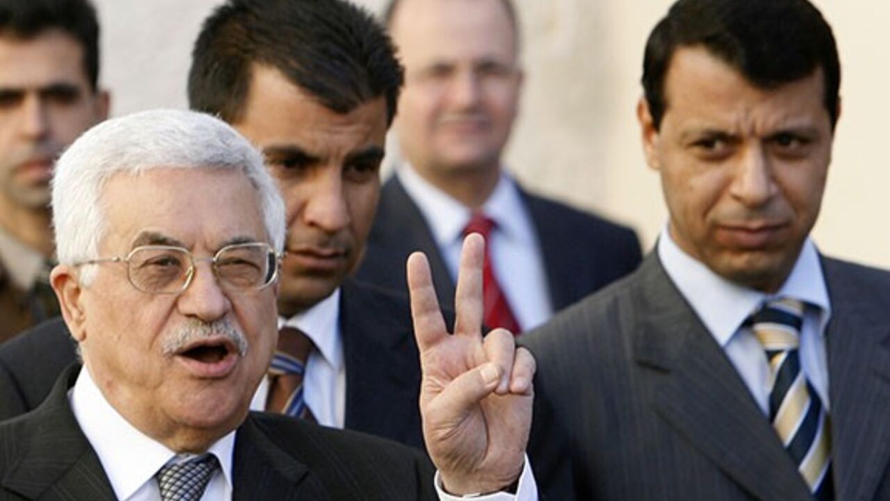 PALESTINIANS-BLAIR/ Palestinian President Mahmoud Abbas (L) gestures as Fatah strongman and lawmaker Mohammed Dahlan looks on (R) after meeting with British Prime Minister Tony Blair at the Palestinian Authority headquarters in the West Bank city of Ramallah December 18, 2006. Abbas told Blair on Monday he would push on with plans for early elections despite bitter opposition from the Hamas government. Blair said it was critical that the international community supported the moderate Abbas in the coming weeks. REUTERS/Eliana A