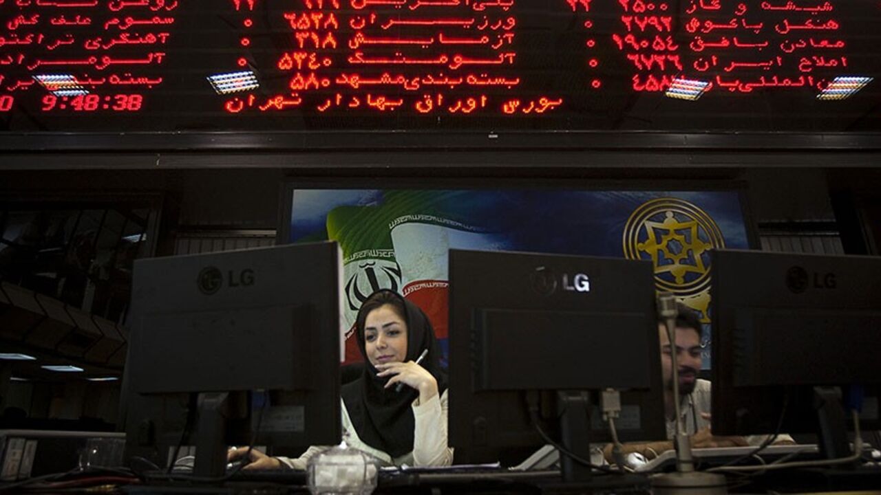IRAN-SANCTIONS/STOCKS EDITORS' NOTE: Reuters and other foreign media are subject to Iranian restrictions on their ability to film or take pictures in Tehran.
An Iranian official works at her desk in the main hall of the Tehran Stock Exchange August 3, 2010. Sanctions against Iran have done nothing to dent a boom in its stock market, as investors bet on a continued rise in company stocks which have been undervalued for years, the head of the Tehran bourse said. REUTERS/Morteza Nikoubazl (IRAN - Tags: BUSINESS POLITICS) - RTR