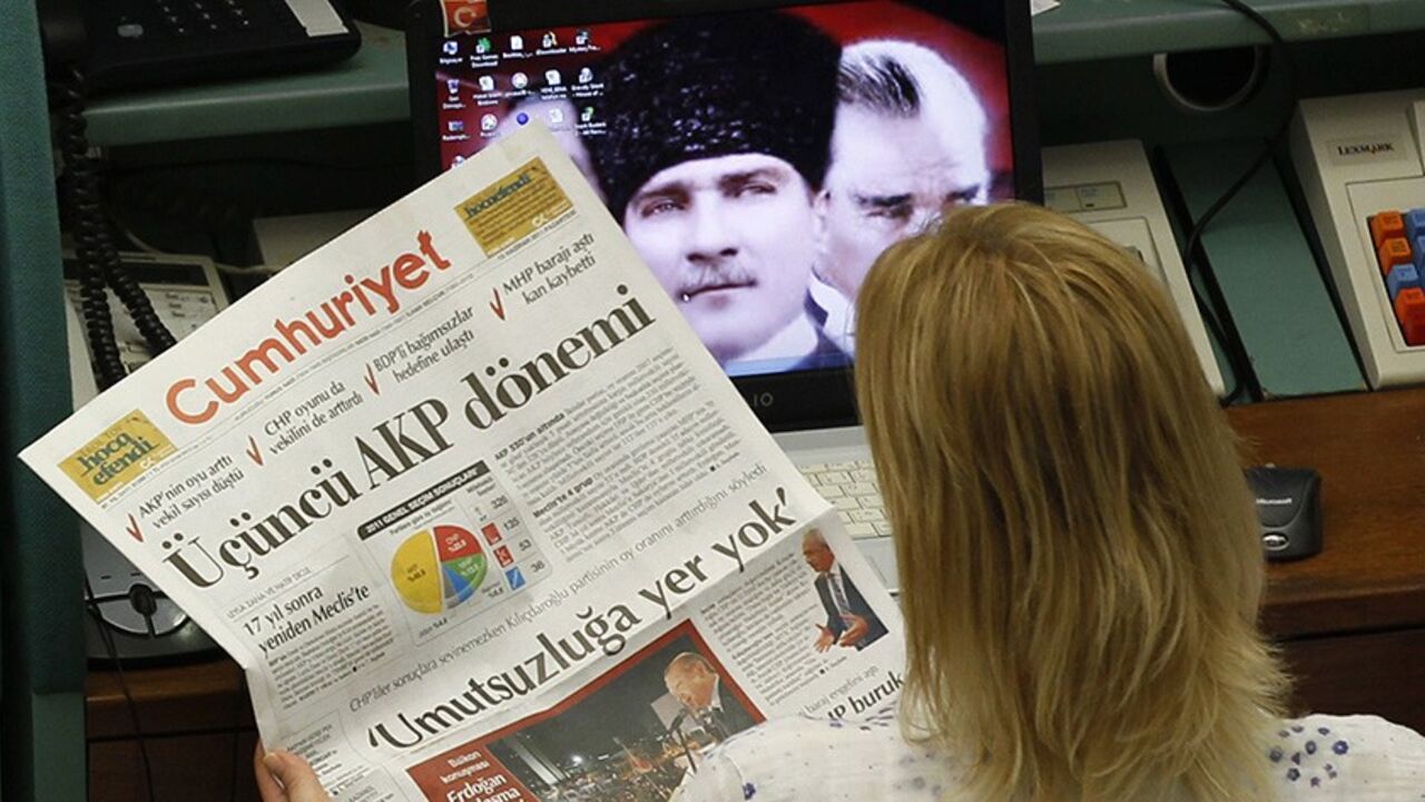 MARKETS-TURKEY/ A trader reads a newspaper with the headline that reads "AK Party Term", during the morning session at the Istanbul Stock Exchange June 13, 2011. Turkish stocks rose on Monday after Prime Minister Tayyip Erdogan's AK Party won Sunday's parliamentary election to secure a third term of single-party rule. The AK Party won 50 percent of the vote to give Erdogan a third consecutive term. But the AK Party's parliamentary majority slipped, as it won 326 seats, down from 331 in the previous assembly. REUTERS/Murad