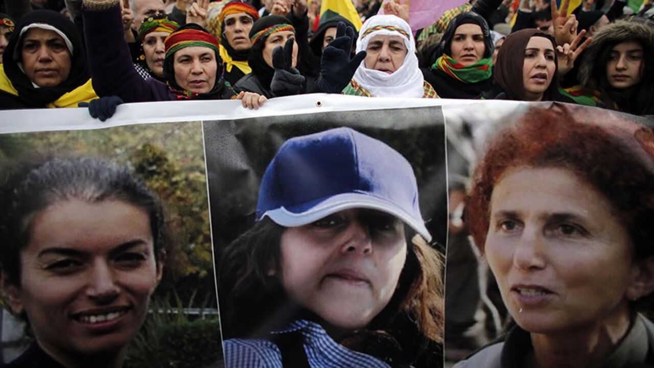 FRANCE-KURDS/ Members of the Kurdish community hold a banner showing the three Kurdish women, Fidan Dogan, Leyla Soeylemez and Sakine Cansiz (L-R), they are paying tribute to, in front of the Gare de l'Est railway station in Paris January 12, 2013. Three female Kurdish activists, including a founding member of the PKK rebel group, were found shot dead in Paris on Thursday in execution-style killings condemned by Turkish politicians trying to broker a peace deal. REUTERS/Christian Hartmann (FRANCE - Tags: POLITICS CRIME L