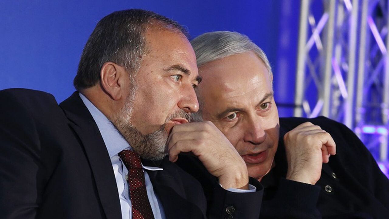 ISRAEL-ELECTION/ Israel's Prime Minister Benjamin Netanyahu (R) converses with former Foreign Minister Avigdor Lieberman during a Likud-Yisrael Beitenu campaign rally in the southern city of Ashdod January 16, 2013. Netanyahu's right-wing Likud party, allied with the nationalist Yisrael Beitenu party, continues to lead opinion polls ahead of Israel's Jan. 22 parliamentary election. REUTERS/Amir Cohen (ISRAEL - Tags: POLITICS ELECTIONS) - RTR3CJ8M