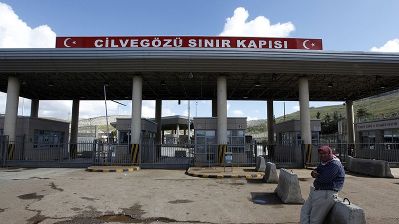 SYRIA-CRISIS/TURKEY-EXPLOSION A man waits in front of the closed Cilvegozu border gate near the town of Reyhanli on the Turkish-Syrian border in Hatay province February 12, 2013. A deadly minibus blast on Turkey's border with Syria was meant to target a Syrian National Council opposition delegation, the group said on Tuesday, but the Turkish authorities said it was too early to apportion blame. The minibus, bearing Syrian number plates, exploded at a crossing on the border near the Turkish town of Reyhanli on Monday, killing 14 people a