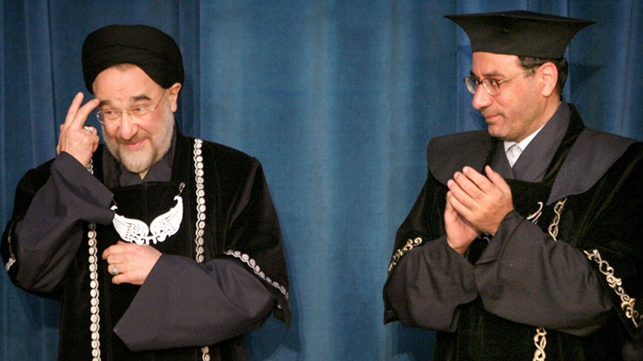 IRAN Dr. Faraji Dana claps as Iranian President Mohammad Khatami receives his honorary international relations doctorate in Tehran. Dr. Faraji Dana (R), president of Tehran University, claps as Iranian President Mohammad Khatami receives his honorary international relations doctorate from Tehran University April 27, 2005. REUTERS/Morteza Nikoubazl - RTR9DQU