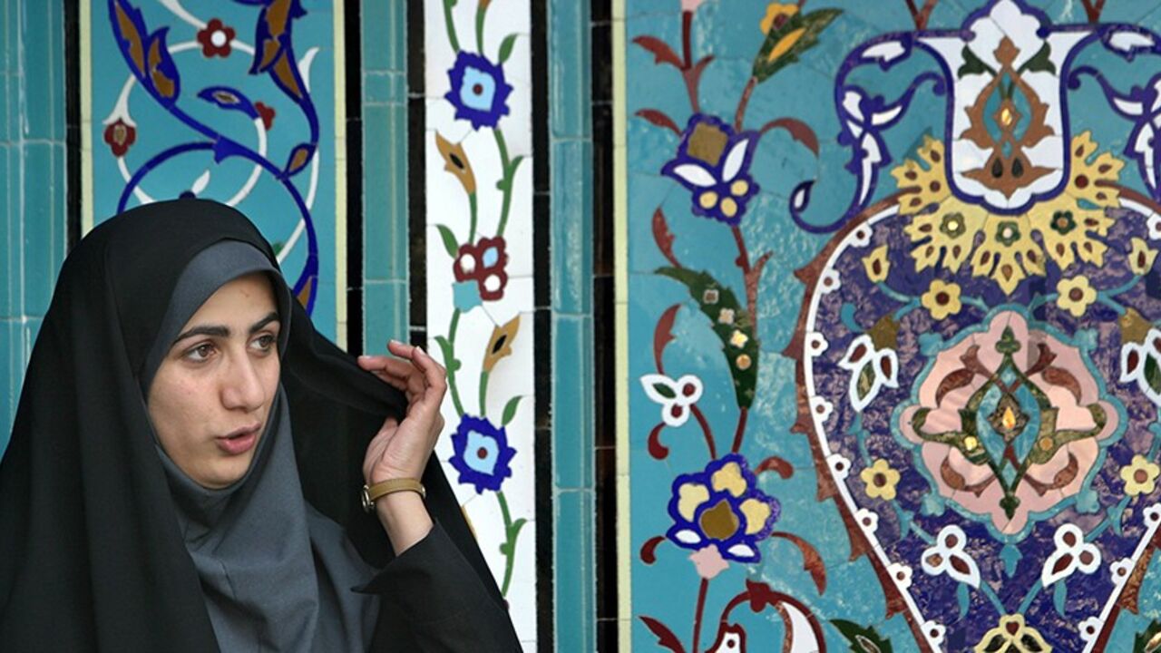 IRAN ELECTION A young Iranian veiled woman stands in front of a mosque at the 18th Tehran International Book Fair May 8, 2005. Aspirants vying to replace outgoing reformist cleric Mohammad Khatami in the June 17 election must first be vetted by a constitutional watchdog known as the Guardian Council which comprises of six clerics and Islamic jurists who have in the past always rejected women hopefuls. REUTERS/Morteza Nikoubazl MN/YH - RTRAIQA