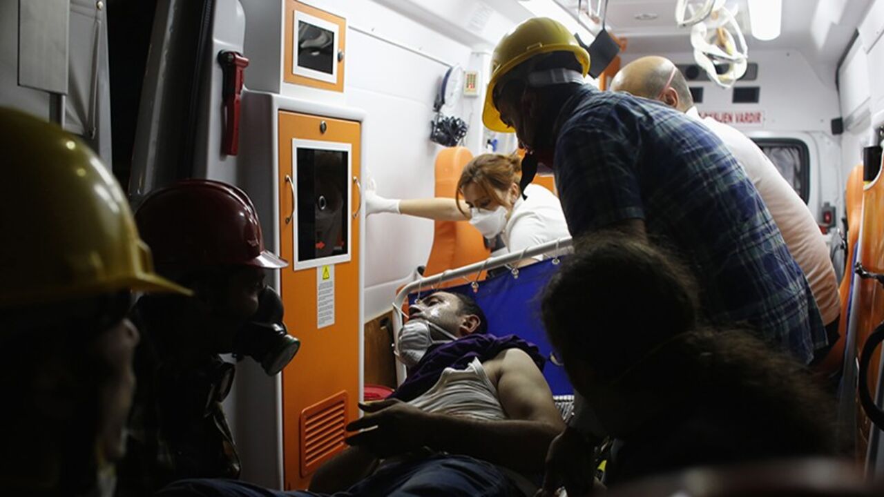 TURKEY-PROTESTS/ An injured protester is carried to an ambulance outside of Gezi Park in central Istanbul June 15, 2013. Thousands of people took to the streets of Istanbul overnight on Sunday, erecting barricades and starting bonfires, after riot police firing teargas and water cannon stormed a park at the centre of two weeks of anti-government unrest. Lines of police backed by armoured vehicles sealed off Taksim Square in the centre of the city as officers raided the adjoining Gezi Park late on Saturday, where protesters