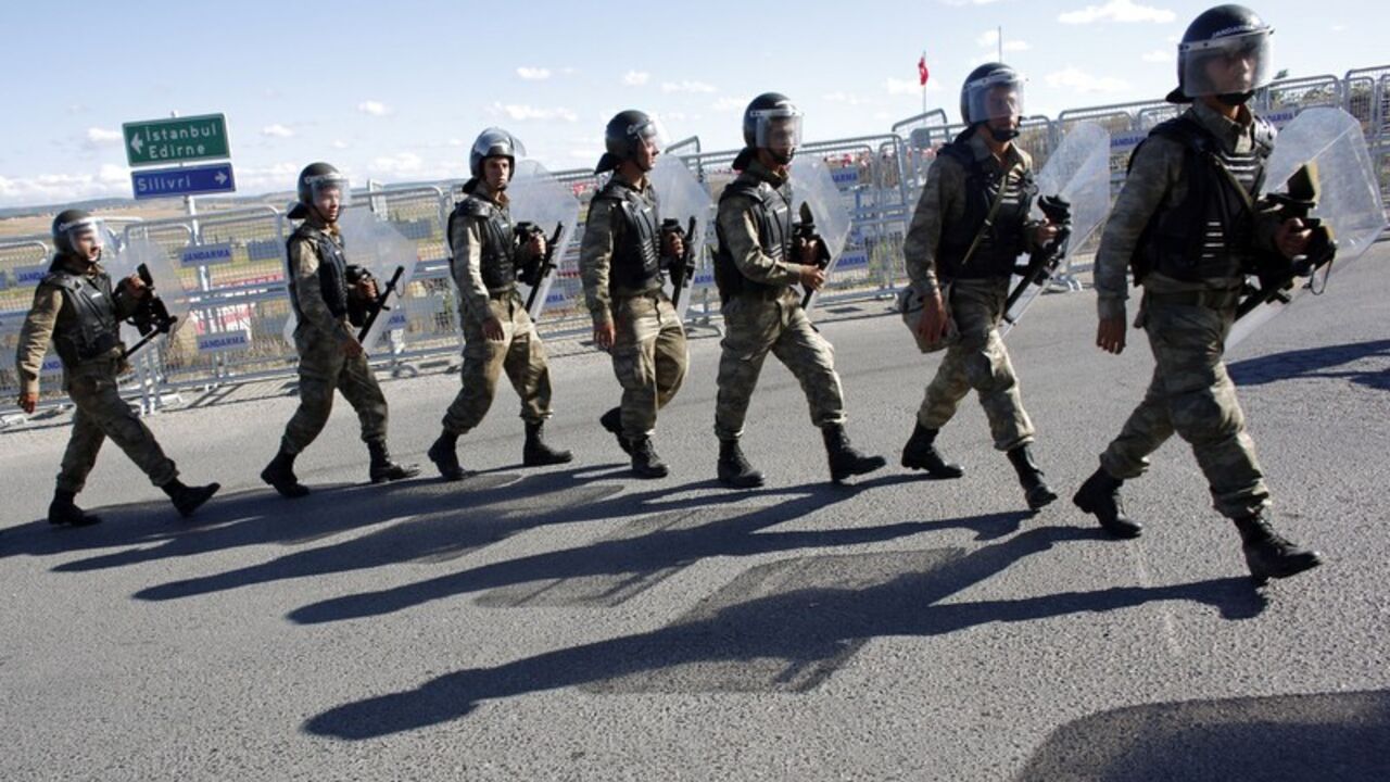 Turkish soldiers walk single file outside a courthouse in Silivri Turkish soldiers walk single file outside a courthouse in Silivri, where a hearing on people charged with attempting to overthrow Prime Minister Tayyip Erdogan's Islamist-rooted government is due to take place, August 5, 2013. A Turkish court on Monday began sentencing nearly 300 defendants accused of plotting to overthrow the government, handing prison sentences of up to 20 years to some and acquitting 21 others. The court was announcing the verdicts individually. Verdicts on high-profile defendants includ
