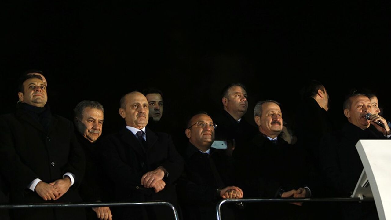 TURKEY-CORRUPTION/ (From L to R) Turkey's European Affairs Minister Egemen Bagis, Interior Minister Muammer Guler, Environment and City Planning Minister Erdogan Bayraktar, Deputy Prime Minister Bekir Bozdag and Economy Minister Zafer Caglayan listen as Prime Minister Tayyip Erdogan addresses his supporters at Esenboga Airport in Ankara December 24, 2013. Turkish ministers Caglayan and Guler resigned on Wednesday after their sons were arrested in a corruption investigation that has pitted the government against the judiciary