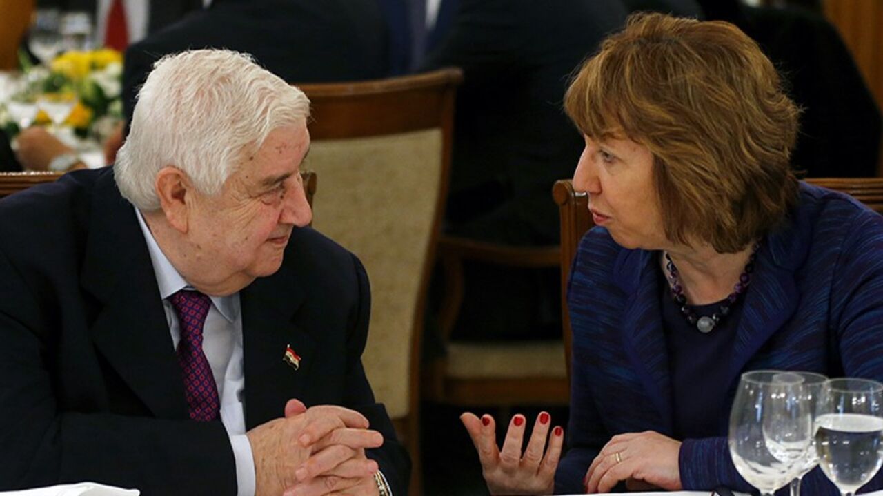 SYRIA-CRISIS/CONFERENCE Syria's Foreign Minister Walid al-Moualem listens to EU foreign policy chief Catherine Ashton (R) as they wait for lunch during a break in the Geneva-2 peace talks in Montreux January 22, 2014. Syria's government and opposition, meeting for the first time, angrily spelled out their mutual hostility on Wednesday at a U.N. peace conference where world powers also offered sharply divergent views on forcing out Bashar al-Assad. REUTERS/Arnd Wiegmann (SWITZERLAND - Tags: CIVIL UNREST POLITICS CONFLICT) - RTX17PZ