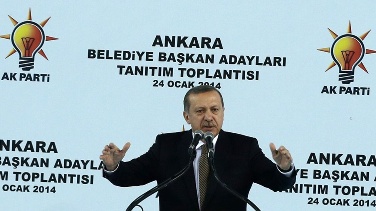 TURKEY-EUROBOND/ Turkey's Prime Minister Tayyip Erdogan addresses his supporters during a meeting of the ruling AK Party (AKP) in Ankara January 24, 2014. Turkey received a vote of confidence in its underlying economic health on Thursday, with foreign investors lapping up a $2.5 billion eurobond issue even as a corruption scandal swirled and the central bank intervened to prop up the lira. The graft investigation, one of the biggest threats to Erdogan's 11-year rule, has shaken Turkey in recent weeks, helping send the lira