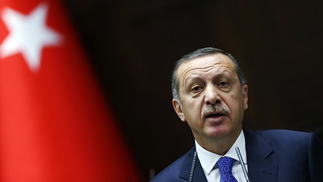TURKEY-CENTRALBANK/ Turkey's Prime Minister Tayyip Erdogan addresses members of parliament from his ruling AK Party (AKP) during a meeting at the Turkish parliament in Ankara January 28, 2014. Erdogan, keen to maintain economic growth ahead of an election cycle starting in two months, has been a vociferous opponent of the higher borrowing costs sometimes needed to bolster currencies, railing against what he describes as an 'interest rate lobby' of speculators seeking to stifle growth and undermine the economy. REUTERS/Umit Bek
