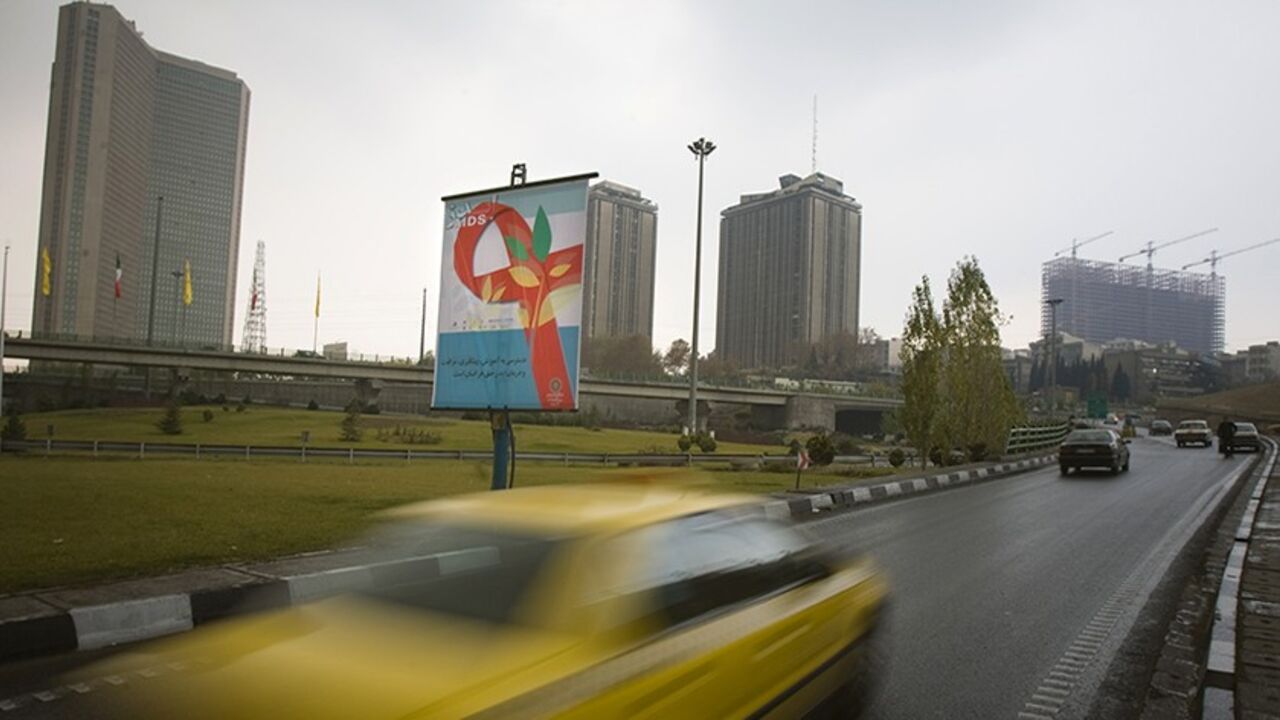 IRAN/ EDITORS' NOTE: Reuters and other foreign media are subject to Iranian restrictions on their ability to report, film or take pictures in Tehran.
A banner with the image of a red ribbon hangs on the side of a highway in Tehran December 1, 2009. The banner reads: ""Having access to training, prevention and treatment of AIDS is the right of all people." REUTERS/Morteza Nikoubazl (IRAN HEALTH SOCIETY) - RTXRBP6