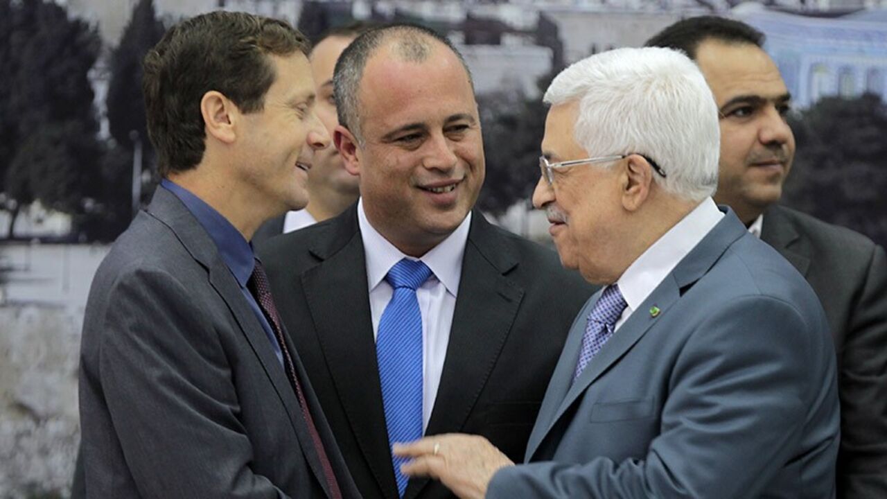 Nic6253186 Israeli MP Labour Party members Isaac Herzog (L) and Hilik Bar (C) shake hands with Palestinian Authority President Mahmoud Abbas as they attend a meeting with Knesset members (Israel's Parliament) in the West Bank city of Ramallah on October 7, 2013. The Palestinians must "recognise Israel as the state of the Jewish people" in order to achieve real peace, Israeli Prime Minister Benjamin Netanyahu said on October 6, 2013. AFP PHOTO/ABBAS MOMANI (Photo credit should read ABBAS MOMANI/AFP/Getty Images)
