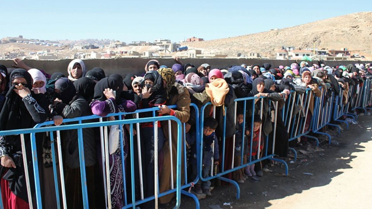 Nic6297764 Syrian families queue to be registered by the United Nations High Commissioner for Refugees (UNHCR) on February 18, 2014 in the Arsal refugee camp in the Lebanese Bekaa valley. More than 130,000 people have been killed since the uprising against President Bashar al-Assad began in March 2011, and millions more have been displaced in what UN officials have described as the worst refugee crisis in two decades. AFP PHOTO / STR (Photo credit should read -/AFP/Getty Images)