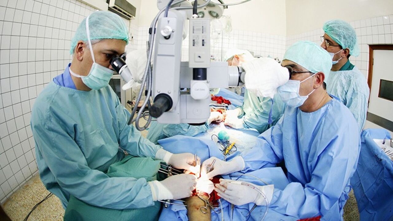51125677BS014_people BAGHDAD, IRAQ - JUNE 6: Dr. Ali Bayrakdar, a plastic surgeon at the Al Wasity Hospital , performs an operation on June 6, 2004 in Baghdad, Iraq. Bayrakdar is a specialist in reconstructive surgery and has done some pioneering work in his field. He and his team deal primarily with wounds sustained through the ongoing violence in Iraq and perform under severely strained conditions with inadequate medical facilities. An average doctor in his position can expect to earn around $350 to $400 a month. Bayrakdar'