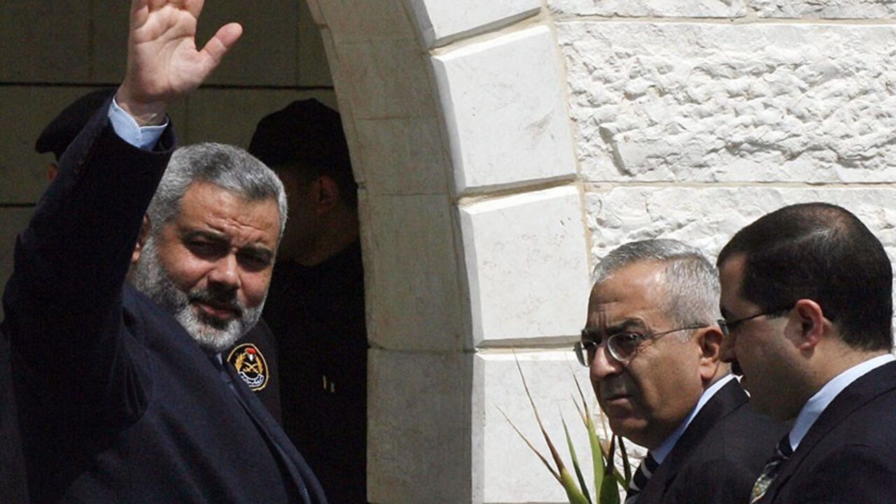 GAZA CITY, -: Palestinian Prime Minister Ismail Haniya, new Finance Minister Salam Fayad (2R) and new Sports and Youth Minister Bassem Naim (R) arrive for the first meeting of the new Palestinian unity cabinet in Gaza City, 18 March 2007. The new Palestinian government held its first cabinet meeting today, vowing to confront rampant lawlessness and end a crippling international aid freeze but facing a continued Israeli boycott. AFP PHOTO/MAHMUD HAMS (Photo credit should read MAHMUD HAMS/AFP/Getty Images)