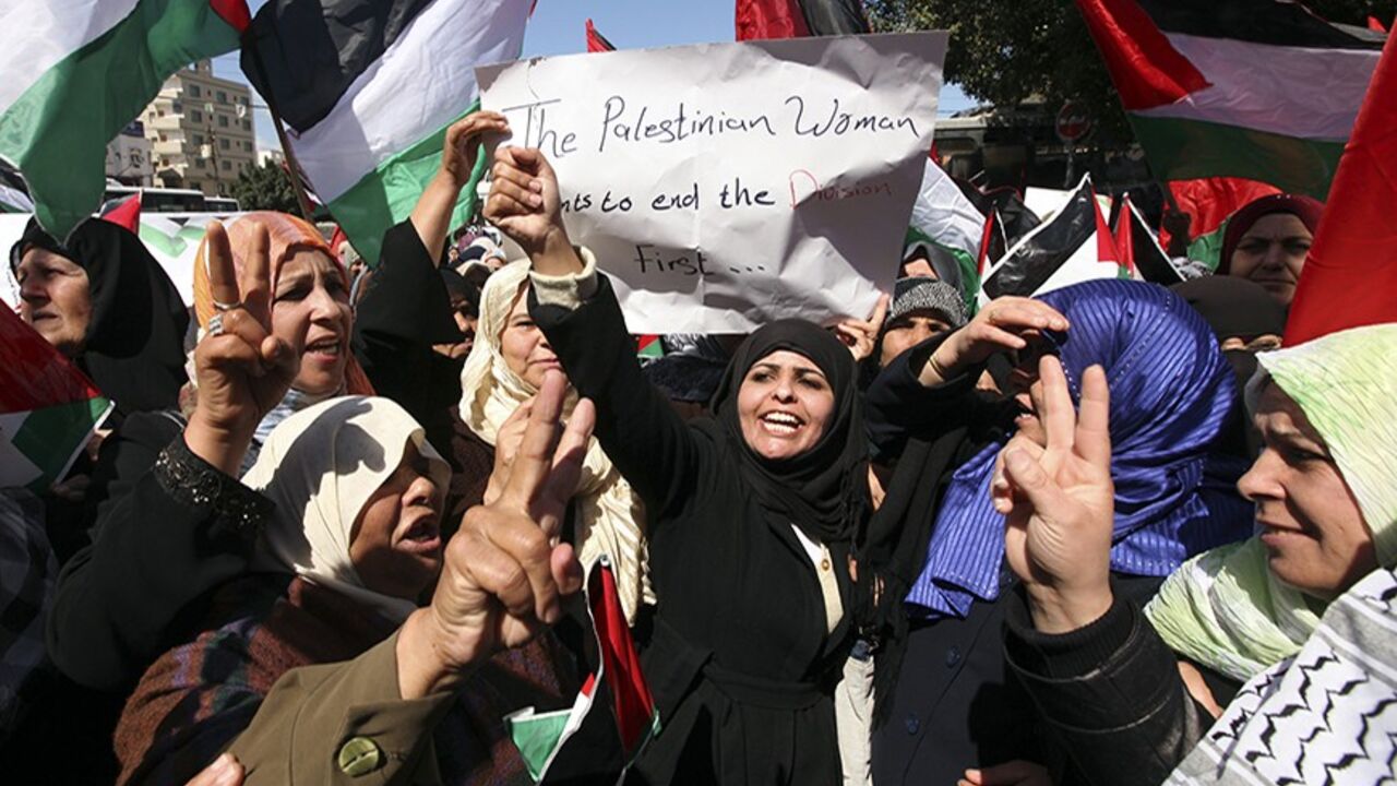PALESTINIANS/ Palestinian women mark International Women's Day with a rally calling for an end to Palestinian divisions, in Gaza City March 8, 2011. Female protesters rallied to voice their frustrations over the unending split between Hamas and Abbas's Fatah movement and the lack of progress towards a peace that will end Israeli occupation and finally give them a state of their own. REUTERS/Mohammed Salem (GAZA - Tags: POLITICS SOCIETY IMAGES OF THE DAY) - RTR2JLMD