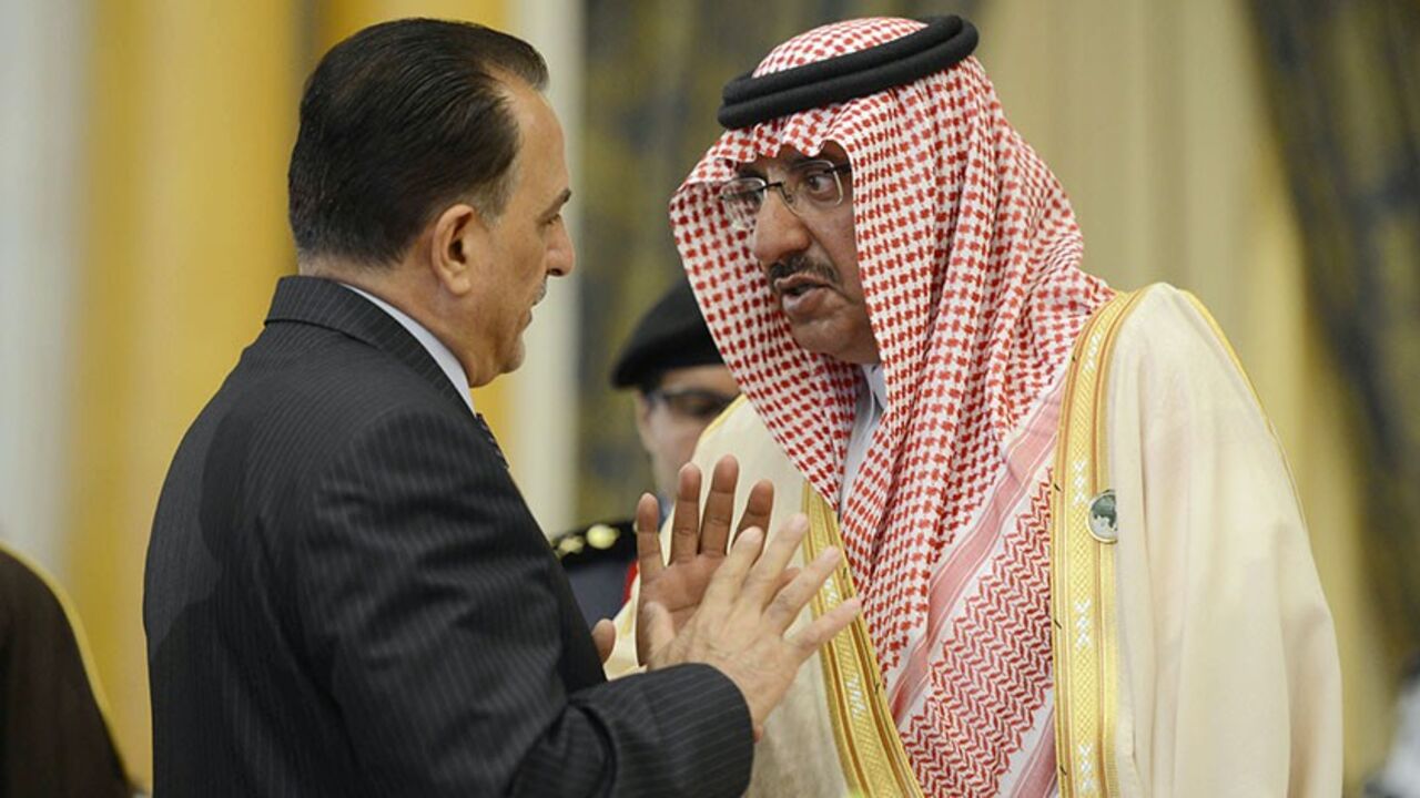 RIYADH/ Saudi Arabia's Interior Minister Mohammed bin Nayef (R) speaks to his Iraqi counterpart Adnan al-Asadi during the conference of Arab Interior Ministers in Riyadh March 13, 2013. Interior ministers of the 22-nation Arab League met in the Saudi capital on Wednesday. REUTERS/Stringer (SAUDI ARABIA - Tags: POLITICS) - RTR3EX57