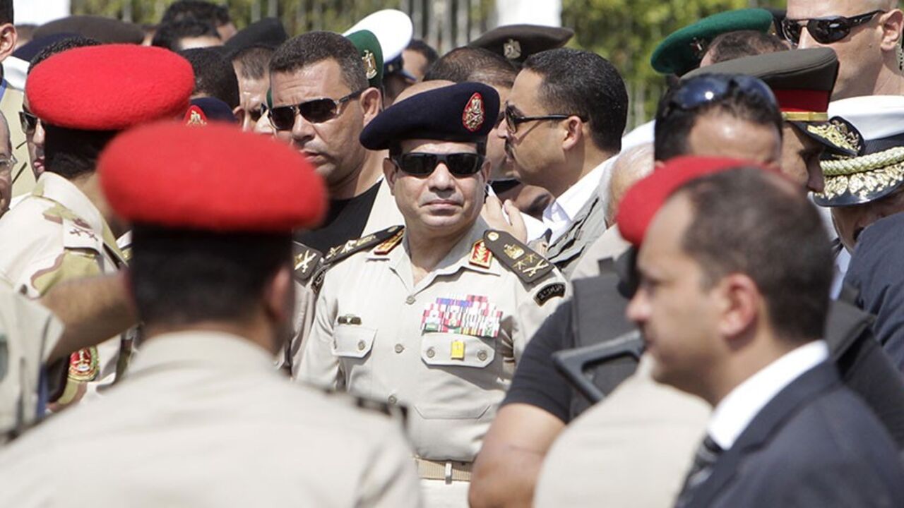 EGYPT-SECURITY/ Army Chief General Abdel Fattah al-Sisi (C) attends the military funeral service of Police General Nabil Farag, who was killed on Thursday in Kerdasa, at Al-Rashdan Mosque in Cairo's Nasr City district September 20, 2013. Egyptian security forces were hunting for supporters of deposed President Mohamed Mursi of the Muslim Brotherhood on Friday after retaking control of a town near Cairo in a crackdown on Islamists. On Thursday, army and police forces stormed Kerdasa where Islamist sympathies run deep and ho