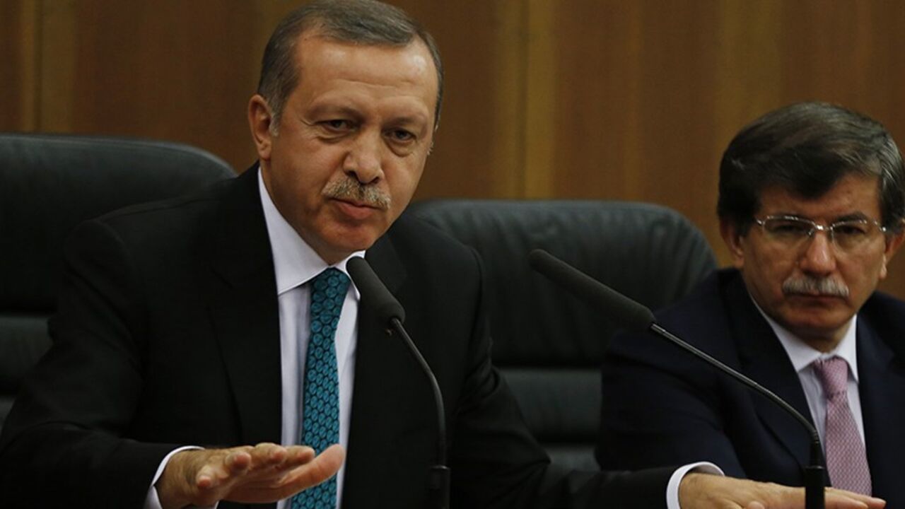 TURKEY-ERDOGAN/GULEN Turkish Prime Minister Tayyip Erdogan addresses the media next to Foreign Minister Ahmet Davutoglu (R) at Esenboga Airport in Ankara November 21, 2013. A feud between Erdogan and an influential Islamic cleric, Fethullah Gulen, has spilled into the open months ahead of elections, highlighting fractures in the religiously conservative support base underpinning his decade in power. REUTERS/Umit Bektas (TURKEY - Tags: POLITICS RELIGION) - RTX15NGG