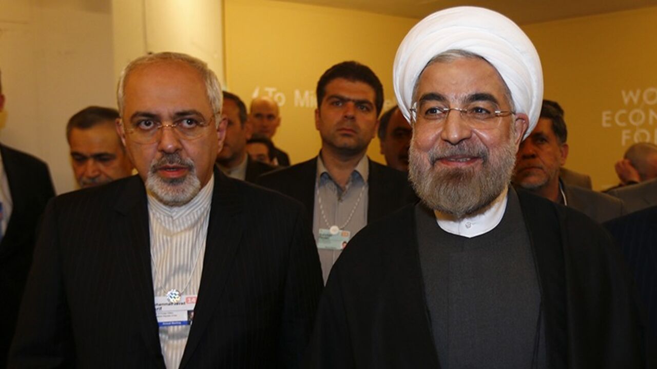 DAVOS/ Iran's President Hassan Rouhani (R) and Iran's Foreign Minister Mohammad Javad Zarif arrive for a meeting during the annual meeting of the World Economic Forum (WEF) in Davos January 22, 2014. REUTERS/Denis Balibouse (SWITZERLAND - Tags: POLITICS BUSINESS) - RTX17PYK
