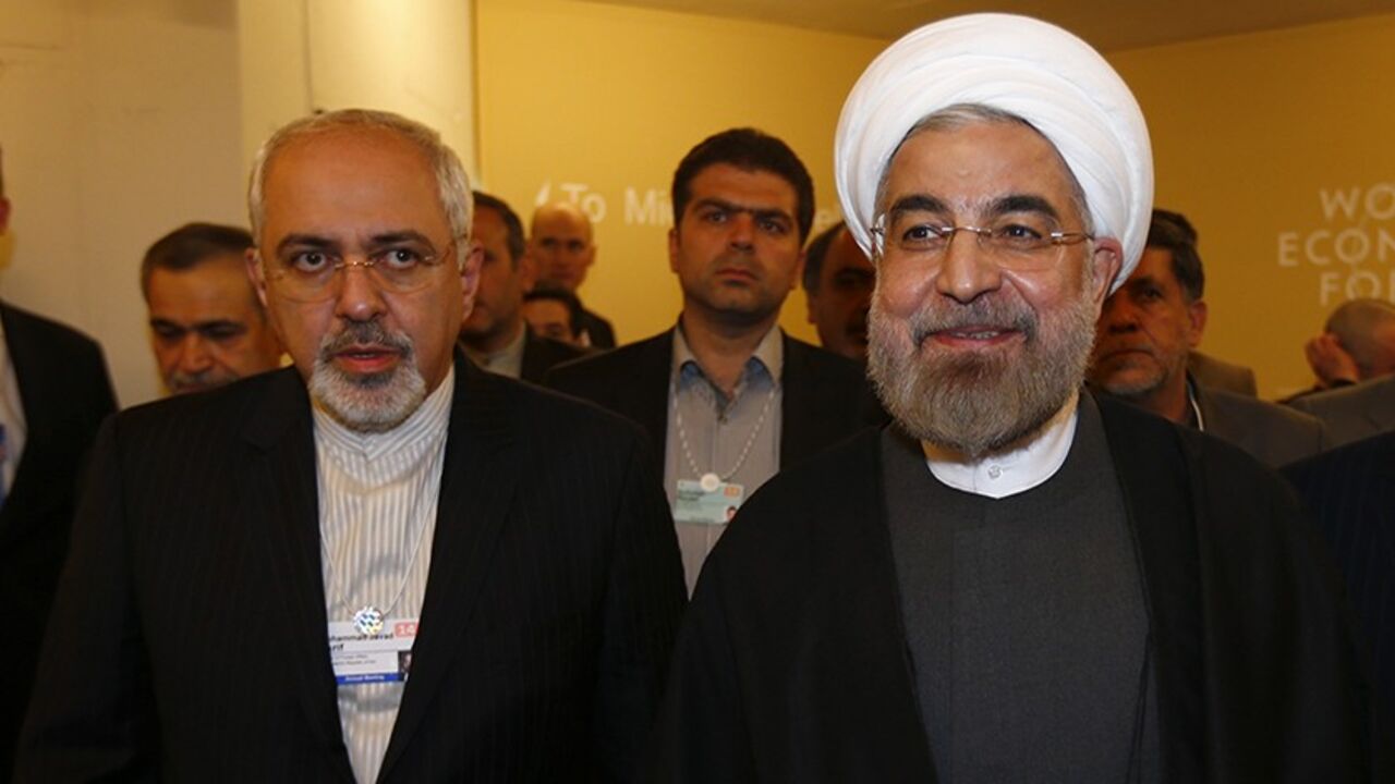 DAVOS/ Iran's President Hassan Rouhani (R) and Iran's Foreign Minister Mohammad Javad Zarif arrive for a meeting during the annual meeting of the World Economic Forum (WEF) in Davos January 22, 2014. REUTERS/Denis Balibouse (SWITZERLAND - Tags: POLITICS BUSINESS) - RTX17PYK