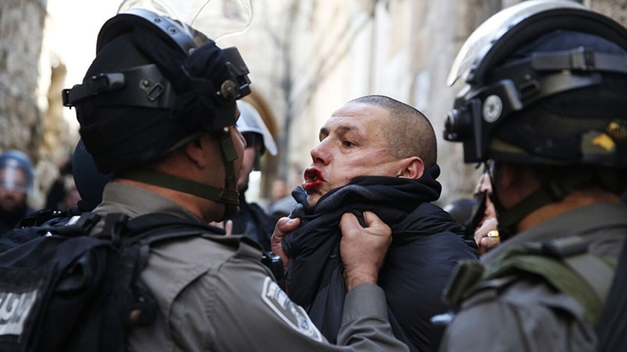 PALESTINIANS-ISRAEL/ An Israeli policeman scuffles with a Palestinian during clashes near Lion's Gate in Jerusalem's Old City February 7, 2014. Tensions briefly ran high on Friday in Jerusalem's Old City following clashes that erupted between Israeli police and stone-throwing Palestinians on a compound known to Muslims as Noble Sanctuary and to Jews as Temple Mount. REUTERS/Darren Whiteside (JERUSALEM - Tags: RELIGION POLITICS CIVIL UNREST TPX IMAGES OF THE DAY) - RTX18CFC
