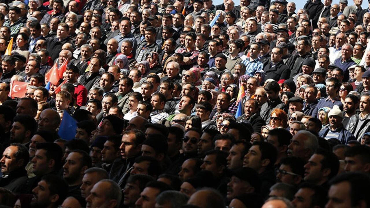 TURKEY/ Supporters of Turkish Prime Minister Tayyip Erdogan listen to his speech during the opening ceremony of a new line of the Ankara Metro in Ankara February 12, 2014. REUTERS/Umit Bektas (TURKEY - Tags: POLITICS) - RTX18NXK