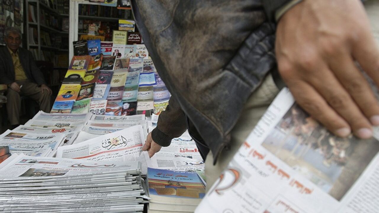 IRAQ/JOURNALISM A resident buys newspapers from a kiosk in Baghdad February 23, 2009. A boom in local media since the U.S.-led invasion in 2003 has given Iraqis a choice between some 200 print outlets, 60 radio stations and 30 TV channels in Arabic, Turkmen, Syriac and two Kurdish dialects. Yet most media outlets remain dominated by sectarian and party patrons who use them for their own ends, and have yet to become commercially sustainable enterprises let alone watchdogs keeping government under scrutiny, the favoured West