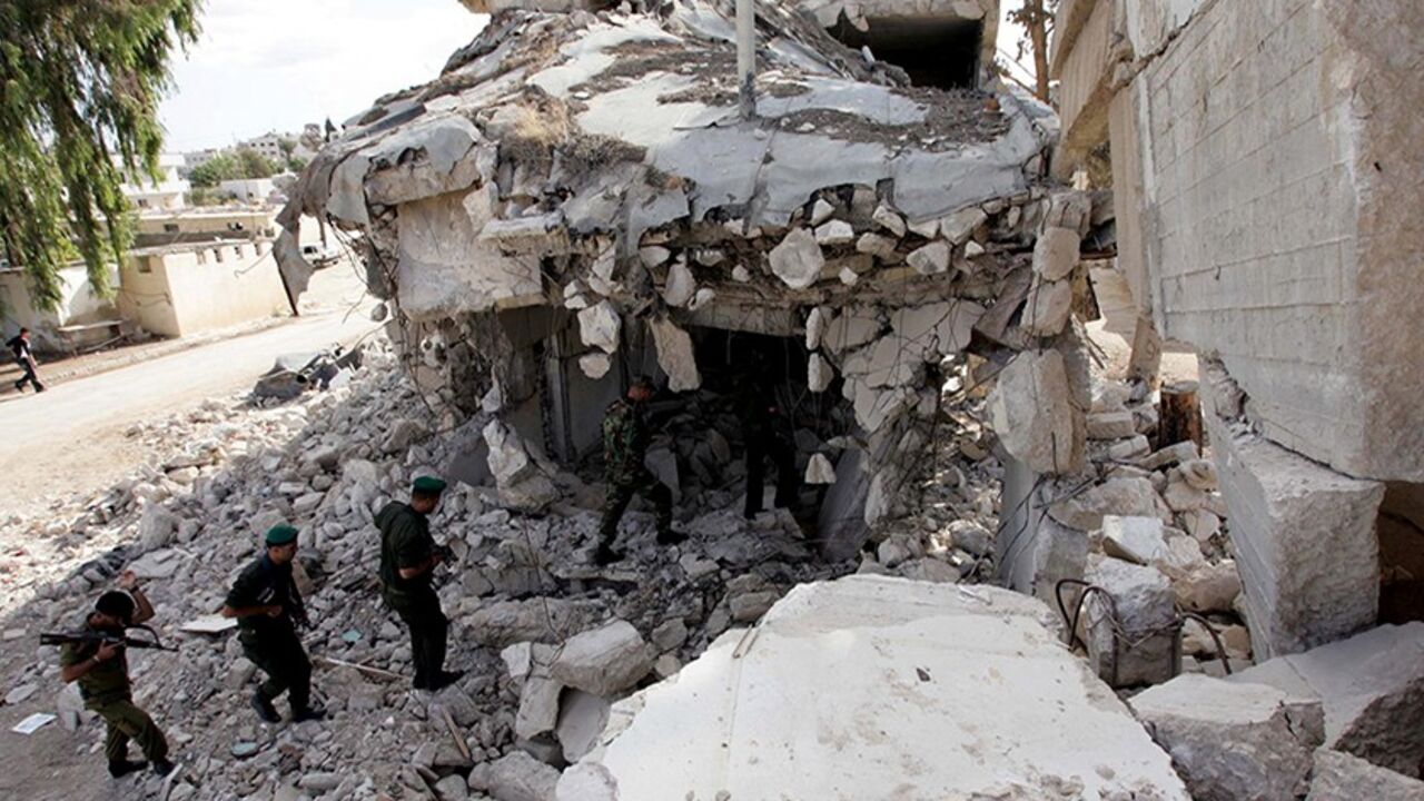 Members of the Palestinian security forces walk amid the ruins of the Muqata in the West Bank city of Jenin November 12, 2007. Palestinian Prime Minister Salam Fayyad's plan calls for rebuilding eight muqatas -- Arabic for headquarters -- and other administrative buildings flattened by Israel across the occupied West Bank after the start of a Palestinian uprising in 2000. Once seen by Palestinians as symbols of sovereignty, the ruins that remain have become permanent reminders of Israel's destructive power 