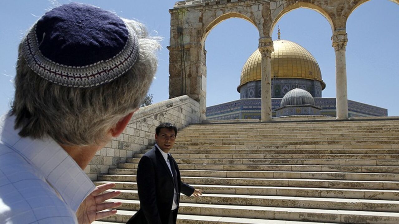 PALESTINIANS-ISRAEL/JERUSALEM Israeli lawmaker Danny Danon (R) stands in front of the Dome of the Rock on the compound known to Muslims as al-Haram al-Sharif and to Jews as Temple Mount, in Jerusalem's Old City July 20, 2010. Danon, a lawmaker of Prime Minister Benjamin Netanyahu's right-wing party, on Tuesday visited the flashpoint religious site in Jerusalem revered by Jews and Muslims, a move that has sparked violence in the past. REUTERS/Ammar Awad (JERUSALEM - Tags: POLITICS RELIGION) - RTR2GKIE