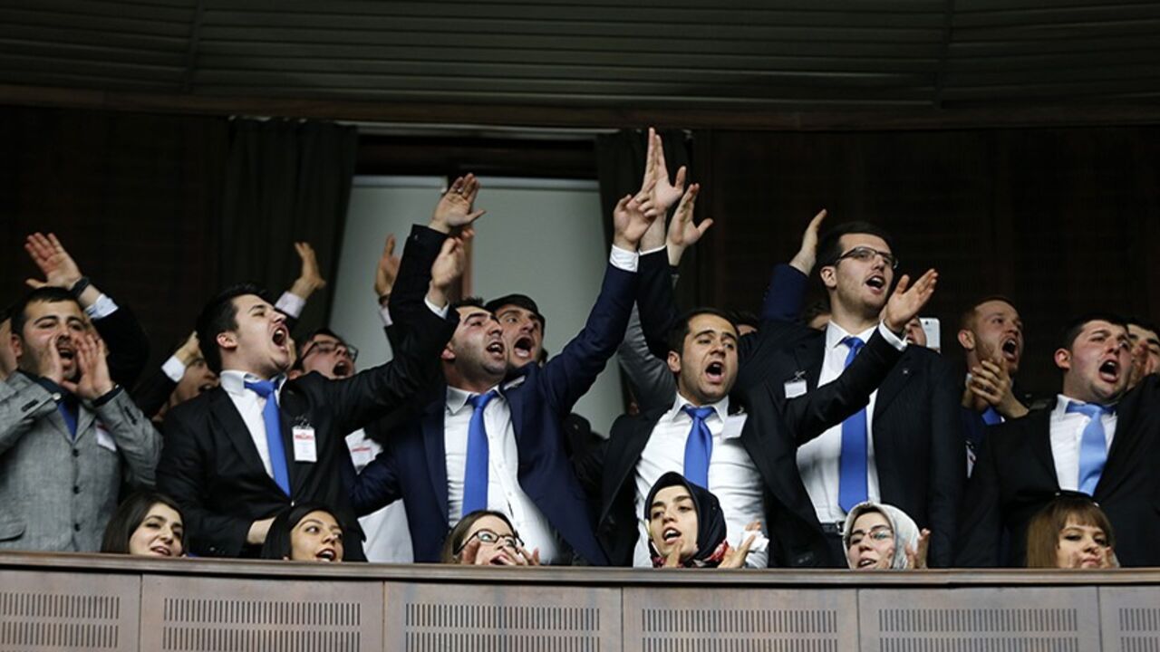 TURKEY-ERDOGAN/RECORDINGS Supporters of Turkey's Prime Minister Tayyip Erdogan react as he addresses the audience during a meeting at the Turkish parliament in Ankara February 25, 2014. Erdogan said on Tuesday voice recordings purportedly of him telling his son to dispose of large sums of money on the day news broke of a graft inquiry were a "treacherous attack" on his office. In a speech to his ruling AK Party deputies in parliament, Erdogan also said the recordings, which appeared on YouTube late on Monday, were a "shameless monta