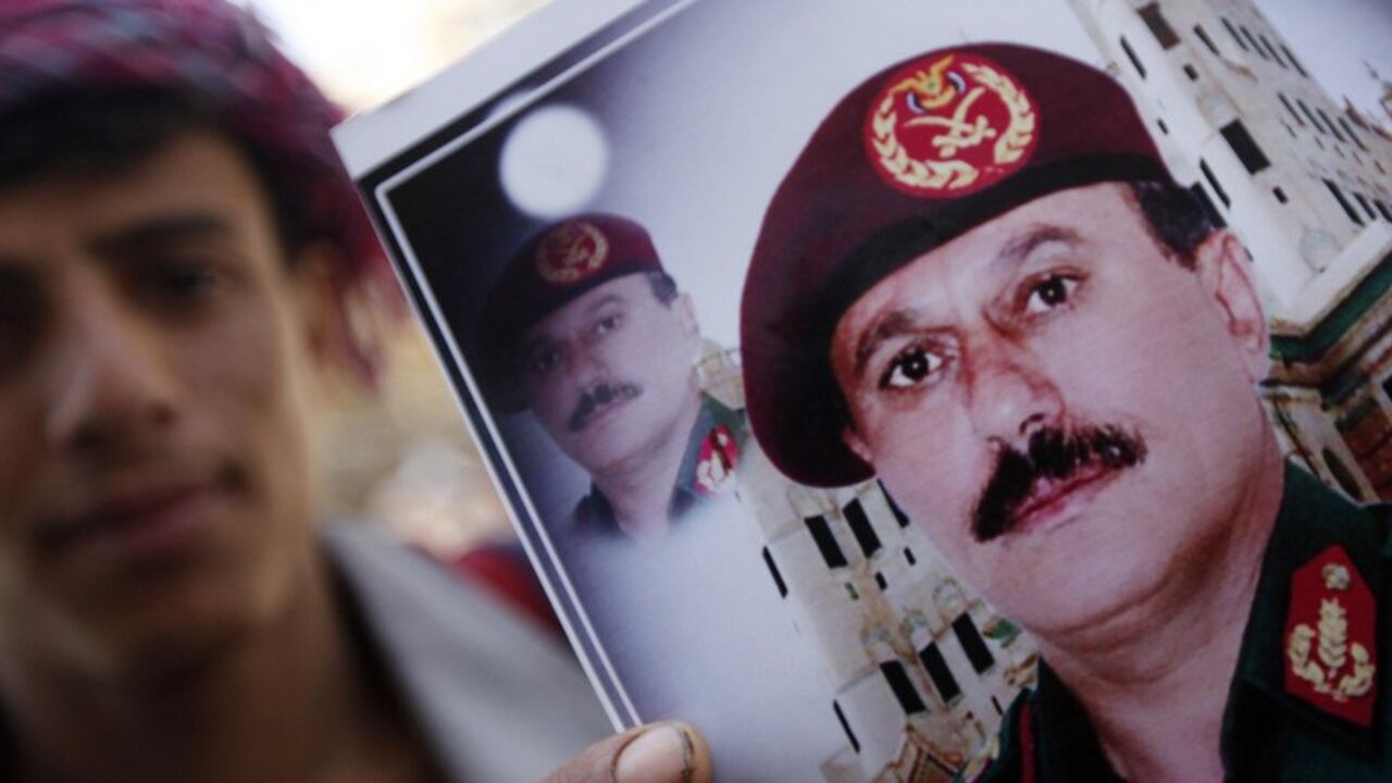 A vendor poses with images of former President Ali Abdullah Saleh in Sanaa A vendor poses with images of former President Ali Abdullah Saleh (bottom) in Sanaa March 1, 2014. Western diplomats say Saleh and former Vice President Ali Salim Al-Beidh are top candidates of a blacklist by a newly created U.N. sanctions committee for Yemen that will impose asset freezes and travel bans on specific individuals who obstruct the country's political transition or commits human rights violations. REUTERS/Mohamed al-Sayaghi (YEMEN - Tags: SOCIETY POLITICS) - RTR3FUWN