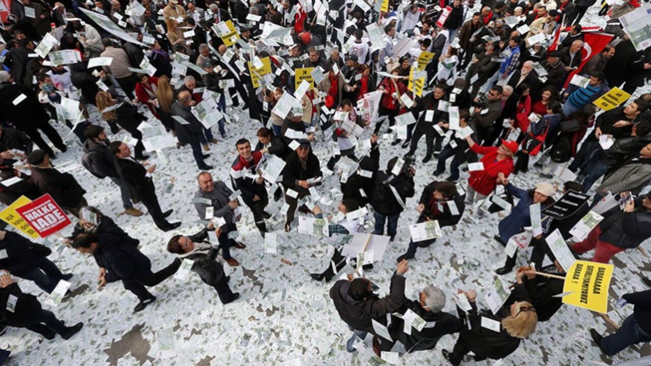 TURKEY-ERDOGAN/ People play around with fake Euro notes during a demonstration against Turkey's Prime Minister Tayyip Erdogan in Ankara March 1, 2014. Supporters from Turkey's main opposition Republican People's Party (CHP) spread 30 million Euros in fake notes on a main street in central Ankara, according to opposition MP Levent Gok, to protest a phone conversation suggesting Erdogan warned his son Bilal to hide large sums of money before police raids during a graft inquiry that reached into the government. Erdogan accuse