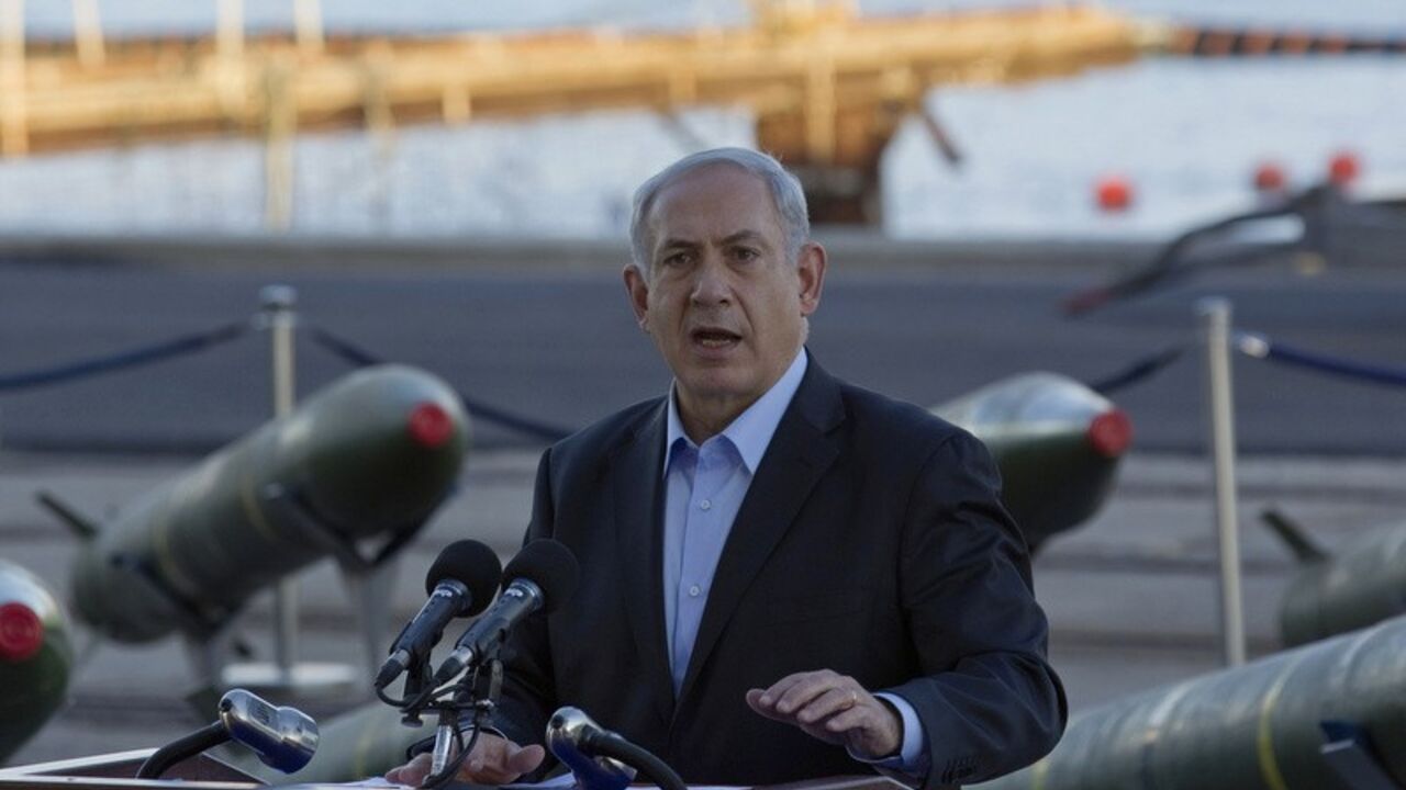 Israel's Prime Minister Netanyahu speaks to the media in front of a display of M302 rockets at a navy base in Eilat Israel's Prime Minister Benjamin Netanyahu speaks to the media in front of a display of M302 rockets, found aboard the Klos C ship, at a navy base in the Red Sea resort city of Eilat March 10, 2014. Netanyahu, displaying on Monday what Israel said were seized Iranian-supplied missiles bound for militants in Gaza, called on the West not to be fooled by Tehran's diplomatic outreach over its nuclear programme. REUTERS/Amir Cohen (ISRAEL - Tags: POLITICS MILITARY CIVIL UNREST) - RTR3GGS8