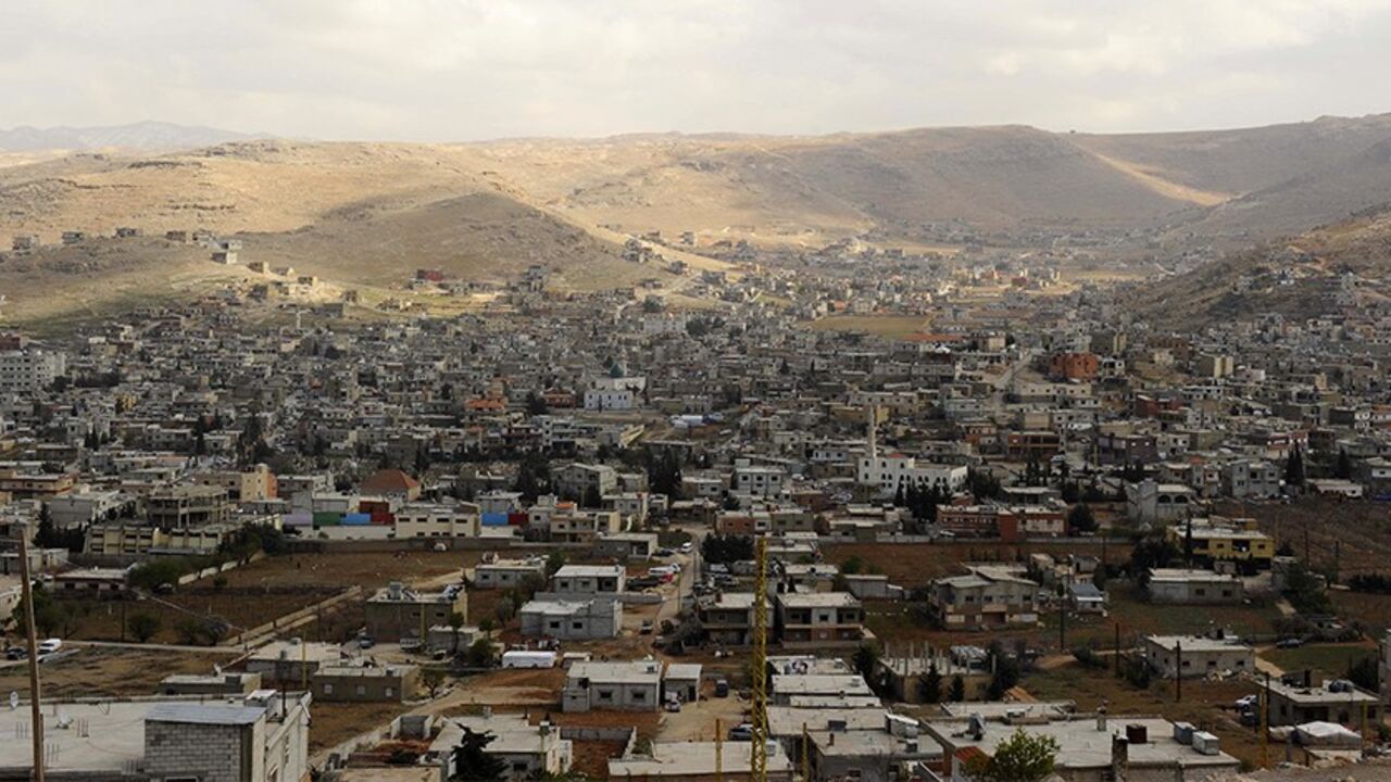 SYRIA-CRISIS/LEBANON A general view shows the Sunni Muslim border town of Arsal, in eastern Bekaa Valley March 19, 2014. The Lebanese army reopened a road between two towns near the Syrian border on Wednesday to try to calm sectarian rivalry aggravated by the conflict in neighbouring Syria. Shi'ite Muslims from the Bekaa Valley town of al-Labwa, where Hezbollah has strong support, had erected sandbag barriers at the weekend to cut off the Sunni Muslim town of Arsal from the rest of Lebanon. REUTERS/Hassan Abdallah (LEBANON - Ta