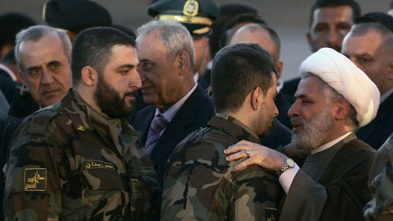 ISRAEL-LEBANON/SWAP Lebanon's President Michel Suleiman (L) and Parliament speaker Nabih Berri (3rd L) look on as Hezbollah's deputy leader Sheikh Naim Kassem (C) greets released Lebanese prisoner Maher Qorani at Beirut airport July 16, 2008. Five Lebanese freed from captivity in Israel were flown to a heroes' welcome in Beirut on Wednesday after Hezbollah returned the bodies of two Israeli soldiers seized in a cross-border raid in 2006. REUTERS/ Mohamed Azakir (LEBANON) - RTX7ZV4
