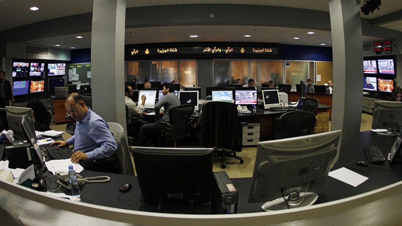 EGYPT/ALJAZEERA-USA/ A general view shows the newsroom at the headquarters of the Qatar-based Al Jazeera satellite channel in Doha February 7, 2011. As much as CNN capitalized on its coverage of the 1990-91 Gulf War, Al Jazeera English has won praise for its on-the-spot reporting and context about the Egyptian protests. It will be talking to U.S. cable operators about deals "in the coming days and weeks," Al Anstey, managing director of Al Jazeera's English-language service said in a telephone interview from Qatar. REUTERS/ Fad