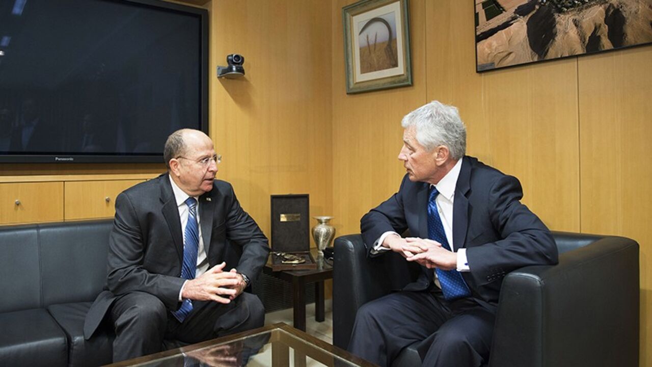 IRAN-NUCLEAR/USA-ISRAEL U.S. Defense Secretary Chuck Hagel (R) and his Israeli counterpart Moshe Yaalon speak during their meeting at the Kirya base in Tel Aviv April 22, 2013. Israel suggested on Monday it would be patient before taking any military action against Iran's nuclear programme, saying during a visit by Hagel there was still time for other options. REUTERS/Jim Watson/Pool (ISRAEL - Tags: POLITICS MILITARY) - RTXYVT1