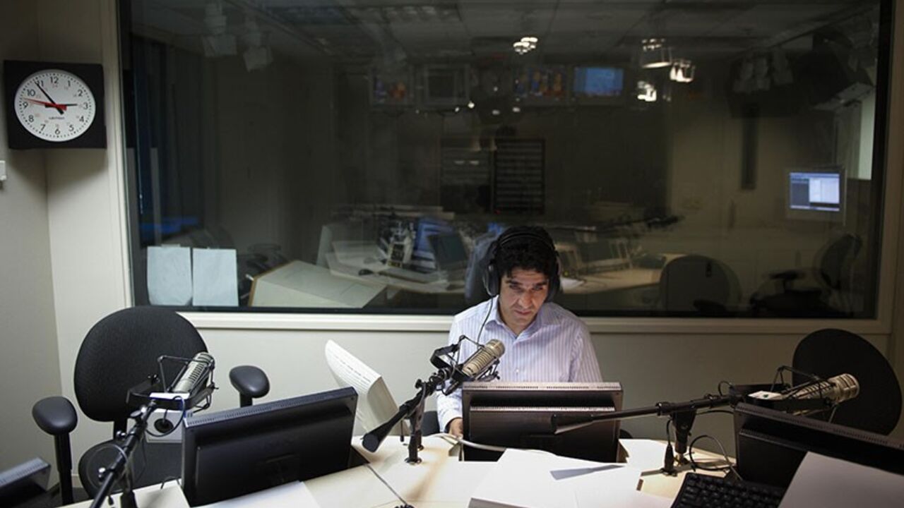 Was2589505 TO GO WITH AFP STORY BY SHAUN TANDON "ENTERTAINMENT-US-AFGHANISTAN-TELEVISION"
Voice Of America (VOA) Afghan Service broadcaster Daoud Sediqi listens to a caller during a show on September 16, 2009 in a studio of the VOA in Washington. Sediqi, the former host of "Afghan Idol", one of Afghanistan's most popular television programs which showcases musical talent, joined the VOA in the US where he was granted asylum to escape Taliban threats. AFP PHOTO/Mandel NGAN (Photo credit should read MANDEL NGAN/AF