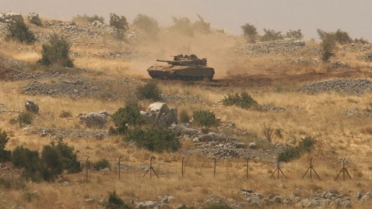 An Israeli tank patrols the Shebaa Farms area, wedged between Lebanon and the Israeli-occupied Golan Heights July 8, 2009. A Lebanese army colonel suspected of collaborating with Israel fled to the Jewish state last week, a Lebanese security source said on Tuesday. REUTERS/Ali Hashisho (LEBANON POLITICS MILITARY) - RTR25GD9